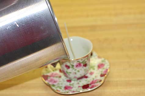 pour wax into teacup