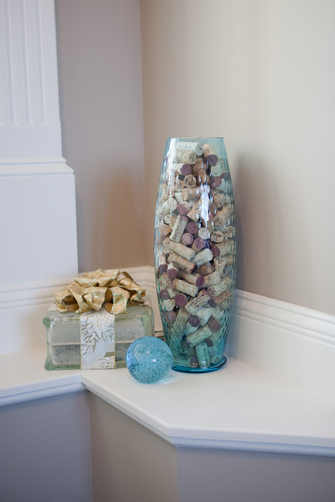 vase of wine corks and lighted box
