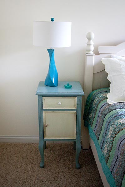 bed tables with teal lamp