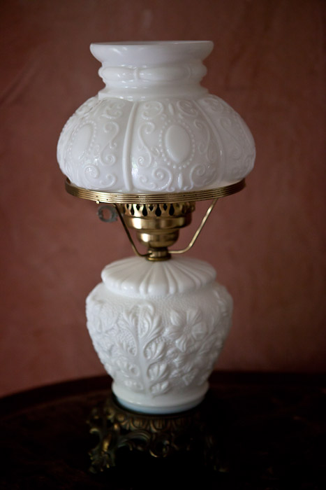 milk glass lamp on table