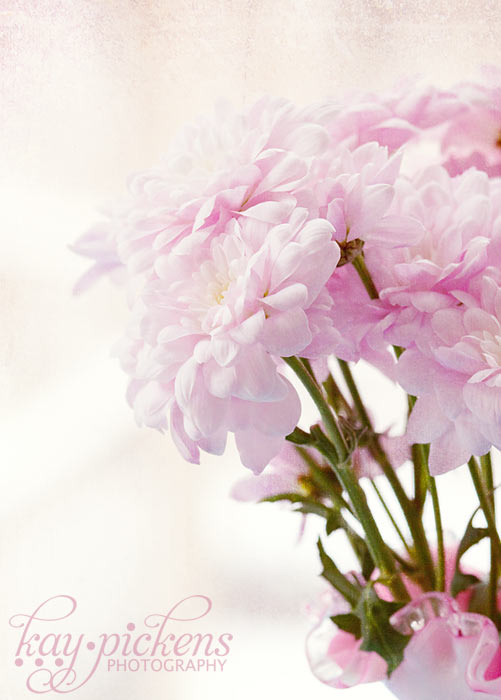 pink flowers in a milk glass vase