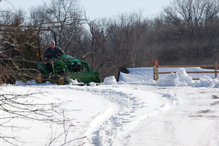 lots of snow John Deere Tractor